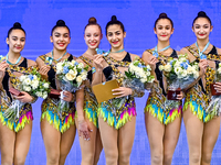 Gold medalists Team Uzbekistan celebrate on the podium after the Group Exercises 5 Hoops Final of the International Rhythmic Gymnastics Tour...