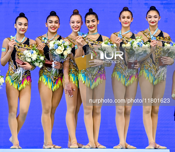 Gold medalists Team Uzbekistan celebrate on the podium after the Group Exercises 5 Hoops Final of the International Rhythmic Gymnastics Tour...