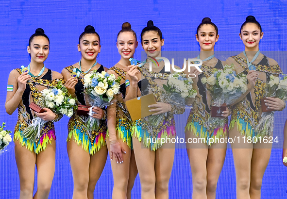 Gold medalists Team Uzbekistan celebrate on the podium after the Group Exercises 5 Hoops Final of the International Rhythmic Gymnastics Tour...