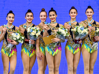 Gold medalists Team Uzbekistan celebrate on the podium after the Group Exercises 5 Hoops Final of the International Rhythmic Gymnastics Tour...