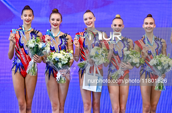 Silver medalist Team ROTC from Belarus celebrates on the podium after the Group Exercises 5 hoops Final of the International Rhythmic Gymnas...