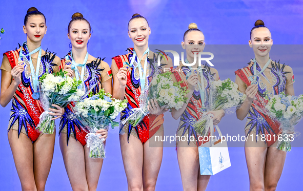 Bronze medalist Team ROTC from Belarus celebrates on the podium after the Group Exercises 3 ribbons 2 balls Final of the International Rhyth...