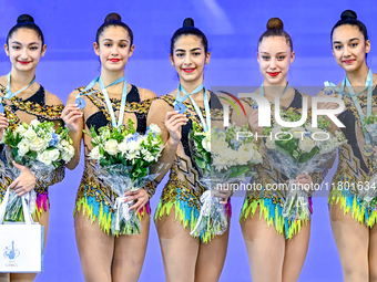 Silver medalist Team Uzbekistan celebrates on the podium after the Group Exercises 3 ribbons 2 balls Final of the International Rhythmic Gym...