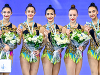 Silver medalist Team Uzbekistan celebrates on the podium after the Group Exercises 3 ribbons 2 balls Final of the International Rhythmic Gym...