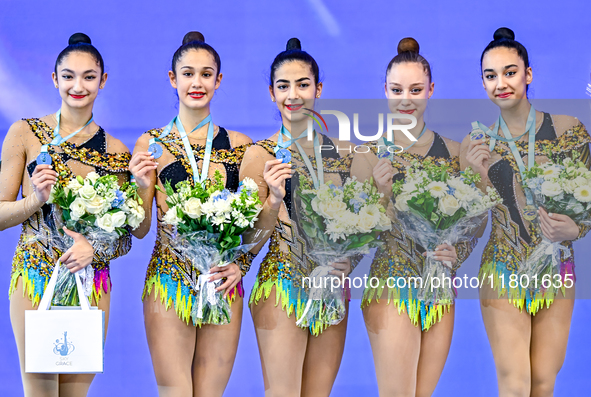 Silver medalist Team Uzbekistan celebrates on the podium after the Group Exercises 3 ribbons 2 balls Final of the International Rhythmic Gym...