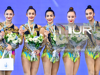 Silver medalist Team Uzbekistan celebrates on the podium after the Group Exercises 3 ribbons 2 balls Final of the International Rhythmic Gym...