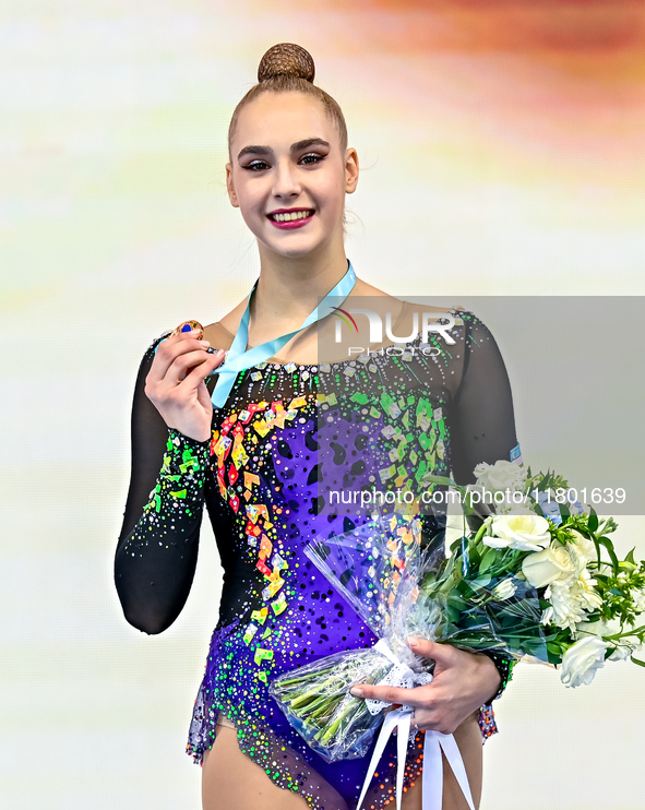 Bronze medalist Natalya Usova of Uzbekistan celebrates on the podium after the Individual Rope Final of the International Rhythmic Gymnastic...