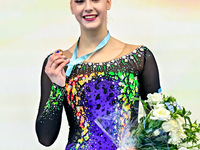 Bronze medalist Natalya Usova of Uzbekistan celebrates on the podium after the Individual Rope Final of the International Rhythmic Gymnastic...