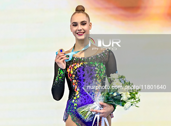 Bronze medalist Natalya Usova of Uzbekistan celebrates on the podium after the Individual Rope Final of the International Rhythmic Gymnastic...