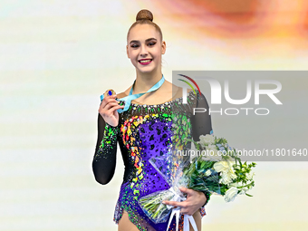 Bronze medalist Natalya Usova of Uzbekistan celebrates on the podium after the Individual Rope Final of the International Rhythmic Gymnastic...