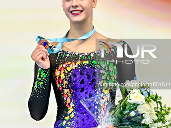 Bronze medalist Natalya Usova of Uzbekistan celebrates on the podium after the Individual Rope Final of the International Rhythmic Gymnastic...