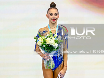 Bronze medalist Polina Frolova of Russia celebrates on the podium after the Individual Hoop Final of the International Rhythmic Gymnastics T...