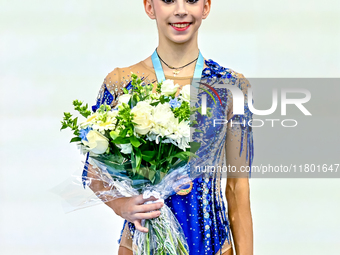 Bronze medalist Polina Frolova of Russia celebrates on the podium after the Individual Hoop Final of the International Rhythmic Gymnastics T...