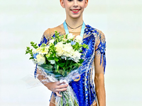 Bronze medalist Polina Frolova of Russia celebrates on the podium after the Individual Hoop Final of the International Rhythmic Gymnastics T...