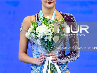 Gold medalist Alina Harnasko of Belarus celebrates on the podium after the Individual Hoop Final of the International Rhythmic Gymnastics To...