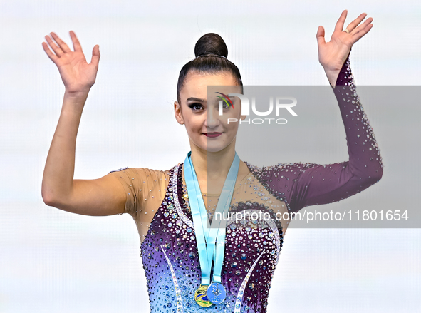 Gold medalist Alina Harnasko of Belarus celebrates on the podium after the Individual Ball Final of the International Rhythmic Gymnastics To...