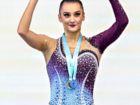 Gold medalist Alina Harnasko of Belarus celebrates on the podium after the Individual Ball Final of the International Rhythmic Gymnastics To...