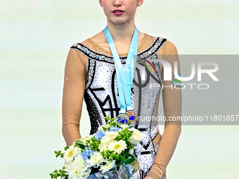 Bronze medalist Takhmina Ikromova of Uzbekistan celebrates on the podium after the Individual Ball Final of the International Rhythmic Gymna...