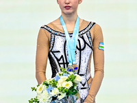 Bronze medalist Takhmina Ikromova of Uzbekistan celebrates on the podium after the Individual Ball Final of the International Rhythmic Gymna...