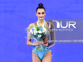 Gold medalist Alina Harnasko of Belarus celebrates on the podium after the Individual Ball Final of the International Rhythmic Gymnastics To...