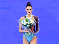 Gold medalist Alina Harnasko of Belarus celebrates on the podium after the Individual Ball Final of the International Rhythmic Gymnastics To...