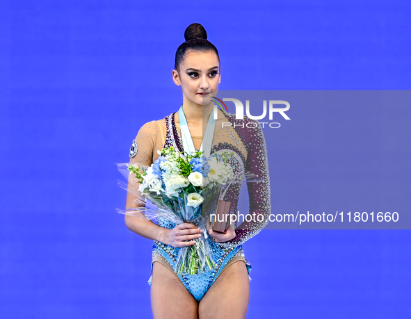 Gold medalist Alina Harnasko of Belarus celebrates on the podium after the Individual Ball Final of the International Rhythmic Gymnastics To...