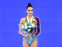 Gold medalist Alina Harnasko of Belarus celebrates on the podium after the Individual Ball Final of the International Rhythmic Gymnastics To...