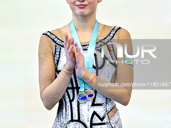 Silver medalist Takhmina Ikromova of Uzbekistan celebrates on the podium after the Individual Clubs Final of the International Rhythmic Gymn...