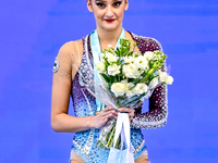 Gold medalist Alina Harnasko of Belarus celebrates on the podium after the Individual Clubs Final of the International Rhythmic Gymnastics T...