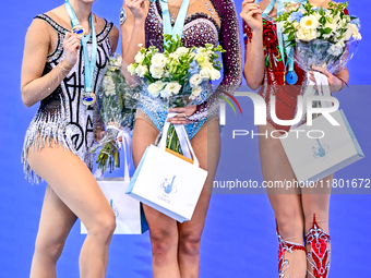 Gold medalist Alina Harnasko of Belarus, silver medalist Takhmina Ikromova of Uzbekistan, and bronze medalist Mariia Borisova of Russia stan...