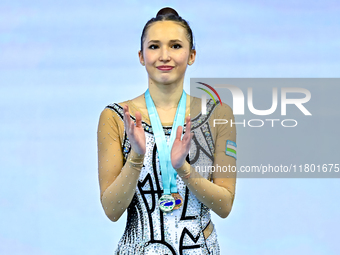 Silver medalist Takhmina Ikromova of Uzbekistan celebrates on the podium after the Individual Clubs Final of the International Rhythmic Gymn...