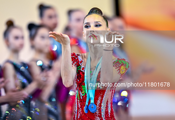 Gold medalist Mariia Borisova of Russia celebrates on the podium after the Individual All-Around Rhythmic Gymnastics Final of the Internatio...