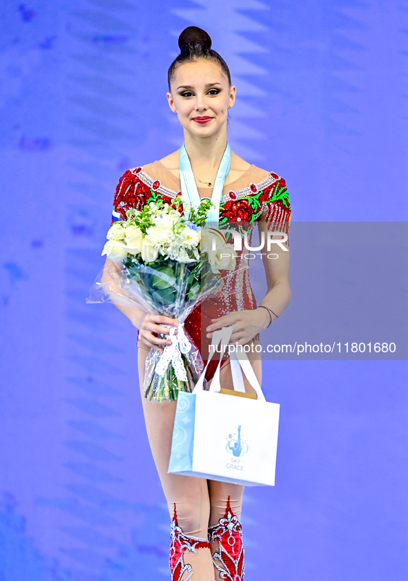 Gold medalist Mariia Borisova of Russia celebrates on the podium after the Individual Ribbon Final of the International Rhythmic Gymnastics...