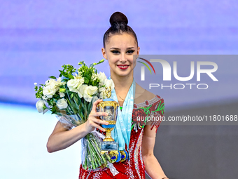 Gold medalist Mariia Borisova of Russia celebrates on the podium after the Individual All-Around Rhythmic Gymnastics Final of the Internatio...