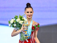 Gold medalist Mariia Borisova of Russia celebrates on the podium after the Individual All-Around Rhythmic Gymnastics Final of the Internatio...