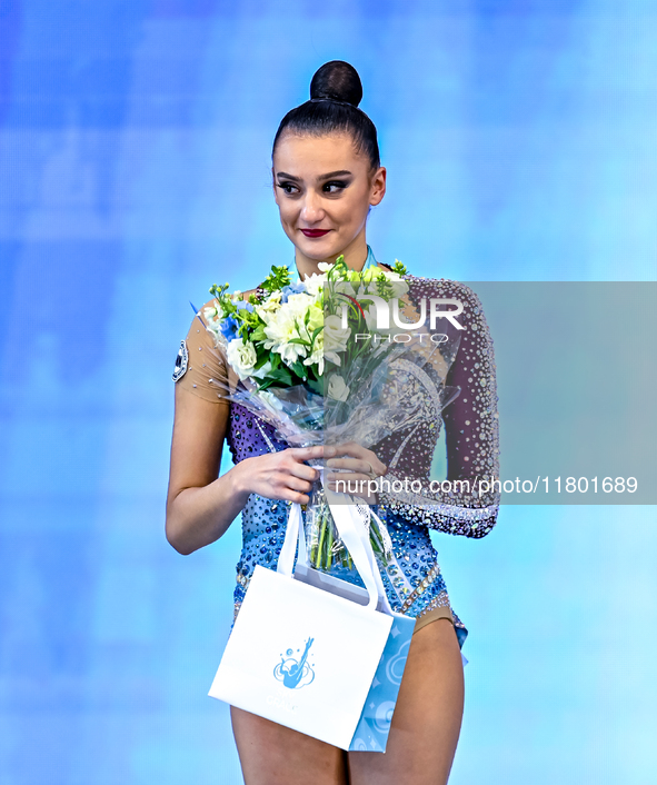 Silver medalist Alina Harnasko of Belarus celebrates on the podium after the Individual All-Around Rhythmic Gymnastics Final of the Internat...