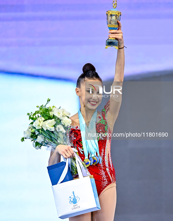 Gold medalist Mariia Borisova of Russia celebrates on the podium after the Individual All-Around Rhythmic Gymnastics Final of the Internatio...