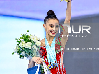 Gold medalist Mariia Borisova of Russia celebrates on the podium after the Individual All-Around Rhythmic Gymnastics Final of the Internatio...