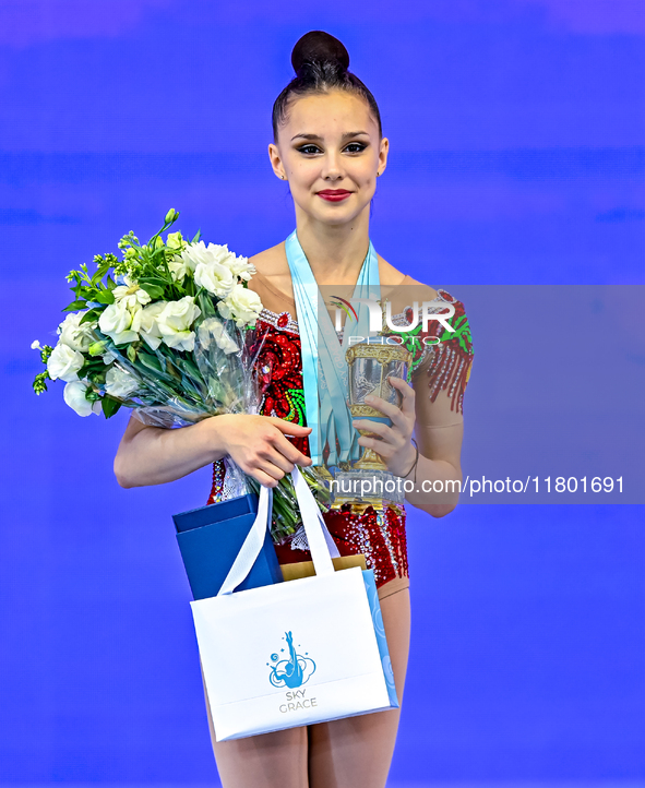 Gold medalist Mariia Borisova of Russia celebrates on the podium after the Individual All-Around Rhythmic Gymnastics Final of the Internatio...