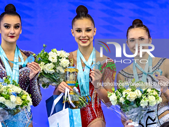 Gold medalist Mariia Borisova of Russia, silver medalist Alina Harnasko of Belarus, and bronze medalist Takhmina Ikromova of Uzbekistan stan...