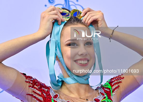 Gold medalist Mariia Borisova of Russia celebrates on the podium after the Individual All-Around Rhythmic Gymnastics Final of the Internatio...