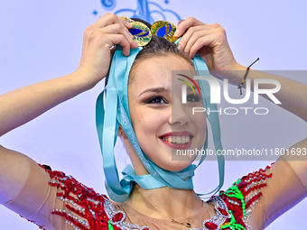 Gold medalist Mariia Borisova of Russia celebrates on the podium after the Individual All-Around Rhythmic Gymnastics Final of the Internatio...