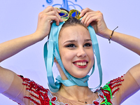 Gold medalist Mariia Borisova of Russia celebrates on the podium after the Individual All-Around Rhythmic Gymnastics Final of the Internatio...