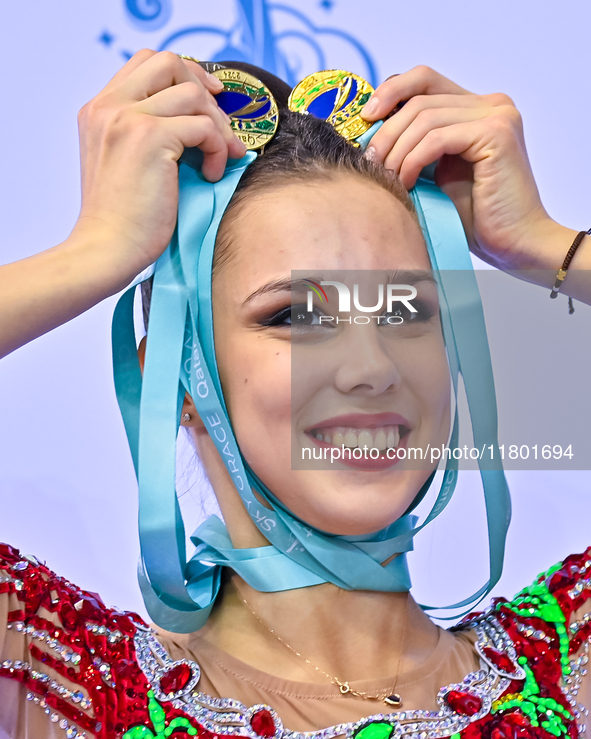 Gold medalist Mariia Borisova of Russia celebrates on the podium after the Individual All-Around Rhythmic Gymnastics Final of the Internatio...