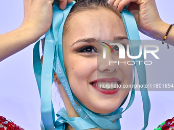 Gold medalist Mariia Borisova of Russia celebrates on the podium after the Individual All-Around Rhythmic Gymnastics Final of the Internatio...