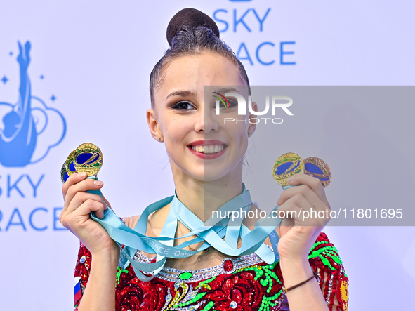 Gold medalist Mariia Borisova of Russia celebrates on the podium after the Individual All-Around Rhythmic Gymnastics Final of the Internatio...