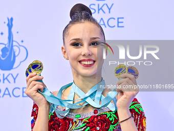 Gold medalist Mariia Borisova of Russia celebrates on the podium after the Individual All-Around Rhythmic Gymnastics Final of the Internatio...