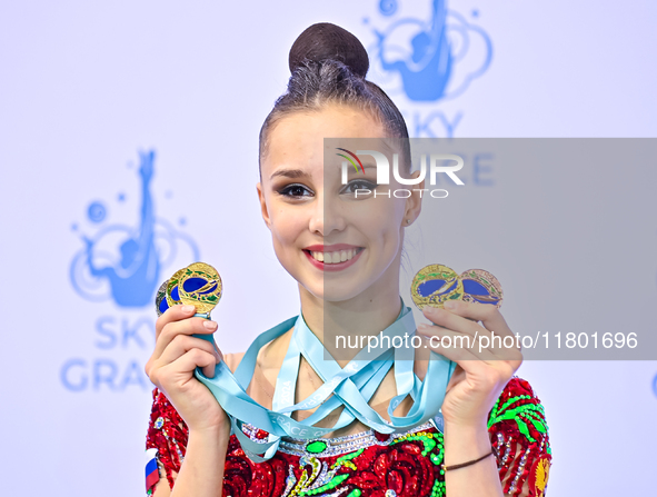 Gold medalist Mariia Borisova of Russia celebrates on the podium after the Individual All-Around Rhythmic Gymnastics Final of the Internatio...