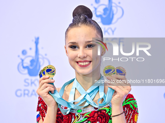 Gold medalist Mariia Borisova of Russia celebrates on the podium after the Individual All-Around Rhythmic Gymnastics Final of the Internatio...