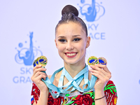 Gold medalist Mariia Borisova of Russia celebrates on the podium after the Individual All-Around Rhythmic Gymnastics Final of the Internatio...